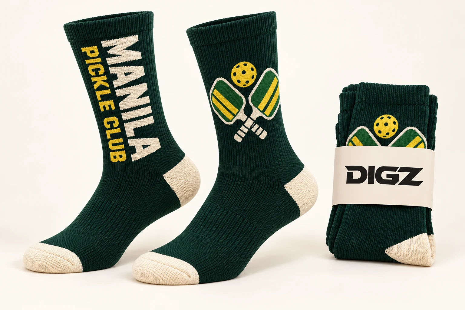 Forest-green fictional Manila Pickle Club socks with bold lettering and crossed-paddle artwork